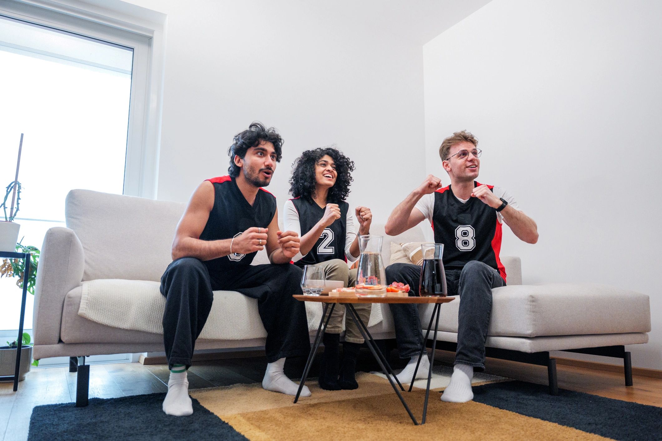 Friends cheering together during a gaming session